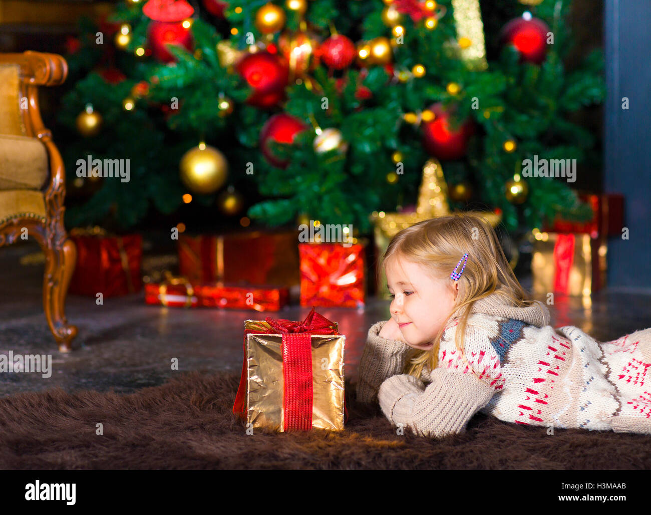 Happy little smiling girl with Christmas gift box indoor Stock Photo ...