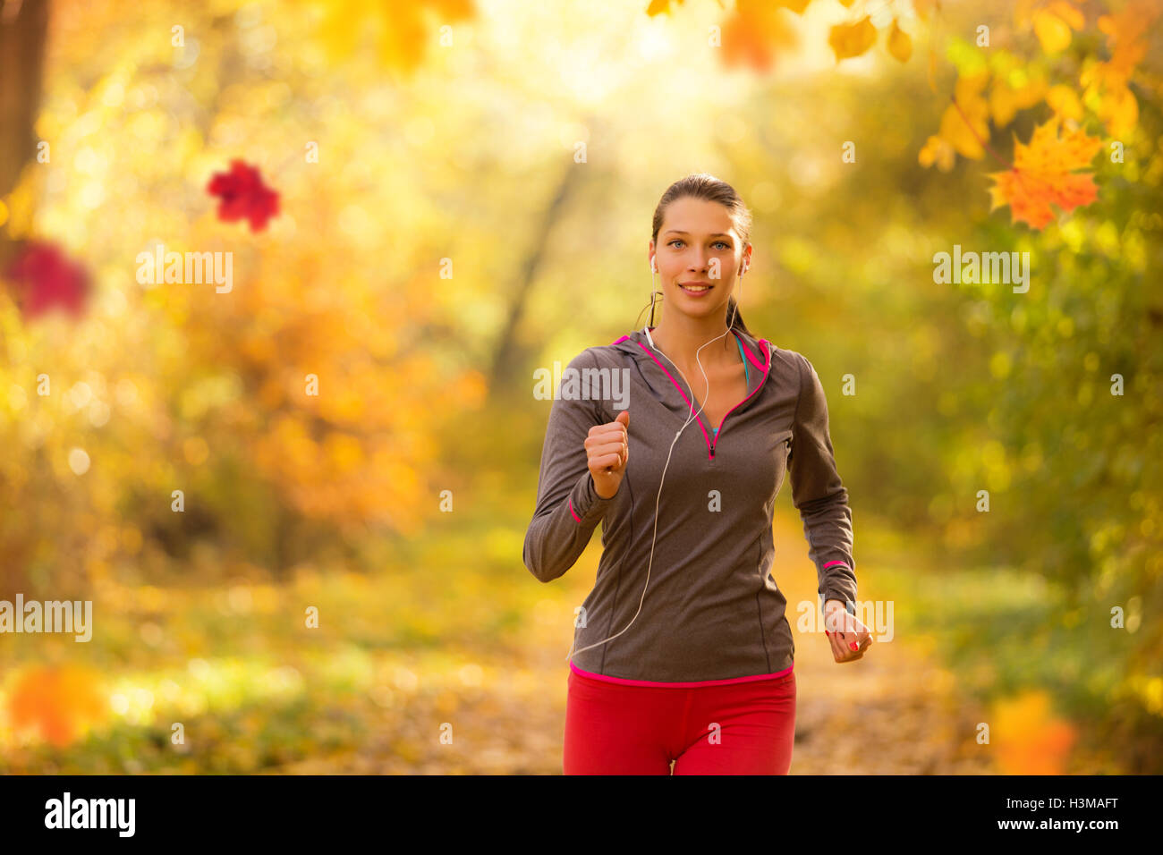 Athlete young woman running in morning sunrise training for marathon and fitness. Healthy active lifestyle in outdoor Stock Photo