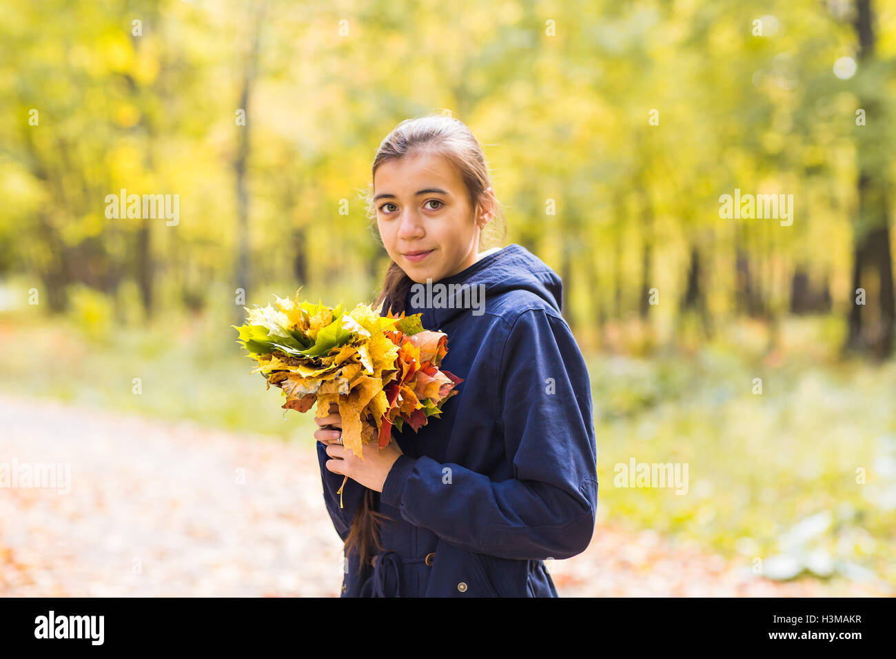 portrait of beautiful teen girl in autumn leaves Stock Photo - Alamy