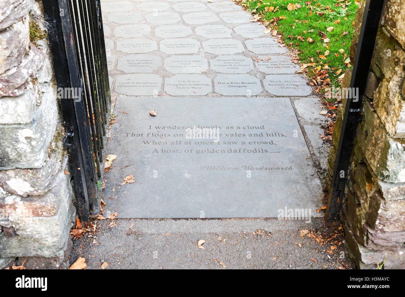 Inscription on paving, entrance to graveyard where poet William Wordsworth is buried, St Oswald's Church Grasmere Lake District Stock Photo