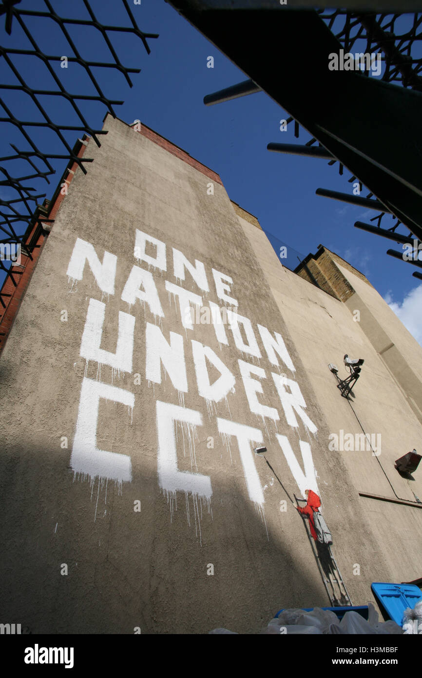 Banksy artwork graffiti One Nation Under CCTV, on wall on Newman Street,London,England,UK,Europe
