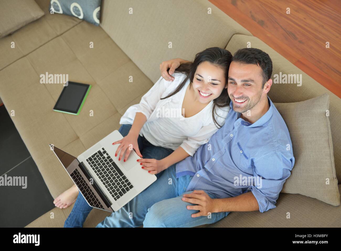 young couple using laptop at home Stock Photo - Alamy