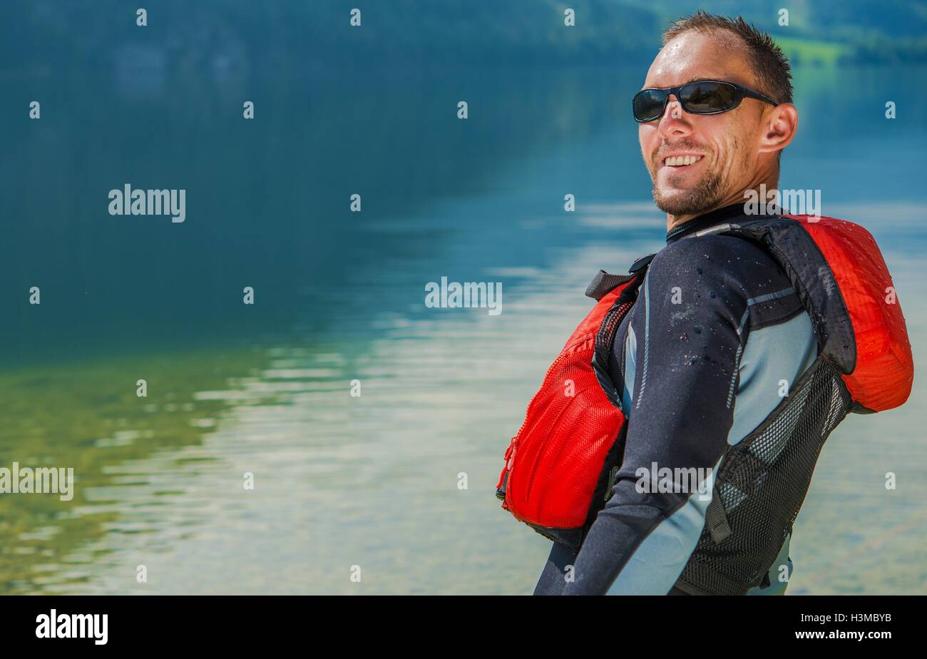 Happy Water Sportsman in Wetsuit. Summer Time Water Fun. Stock Photo