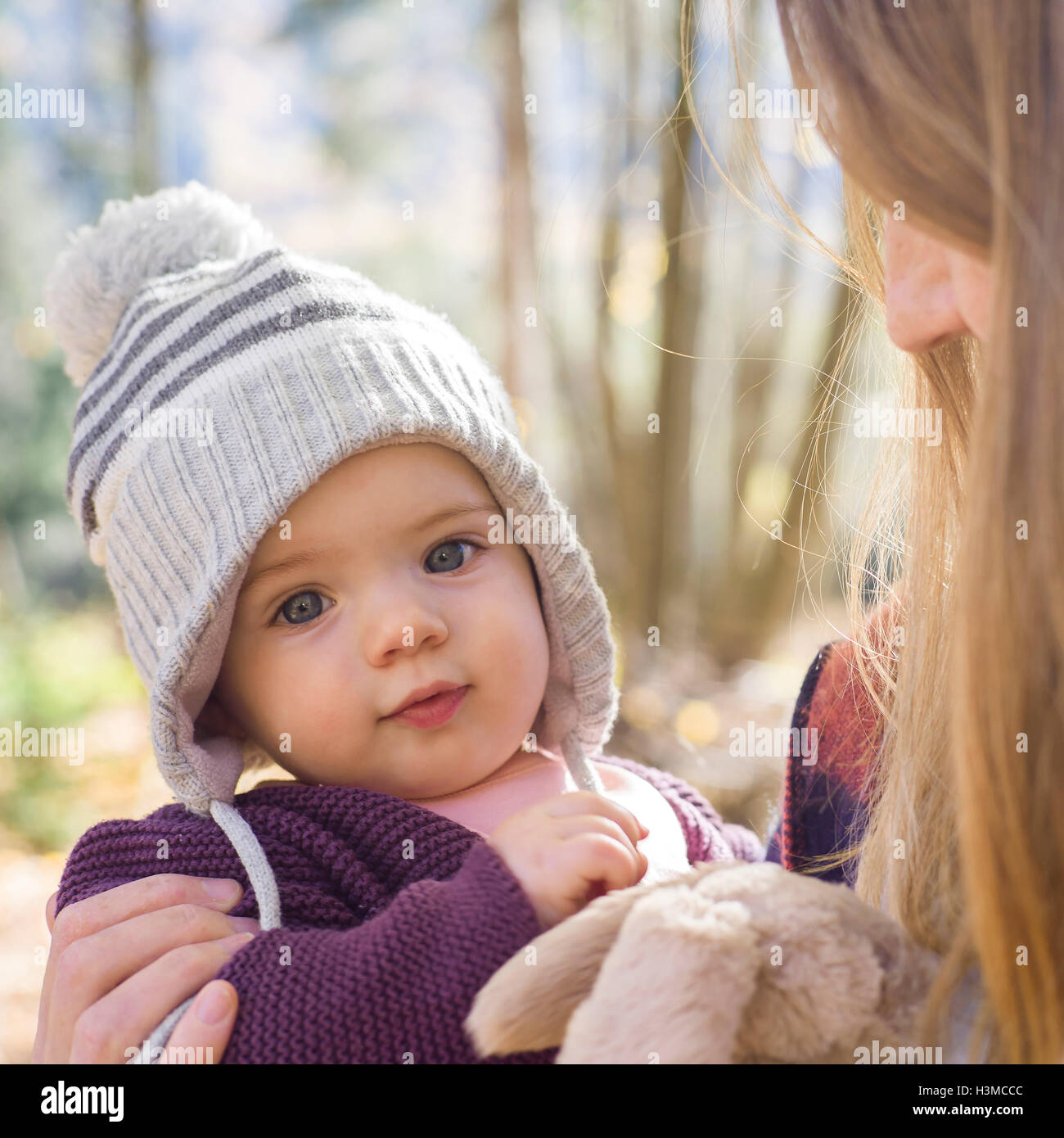 Portrait of baby girl wearing knit hat looking at camera Stock Photo