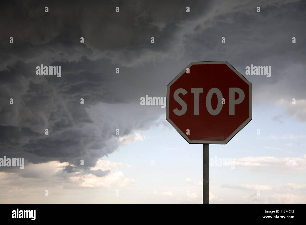 Stop sign on dark cloudy day Stock Photo