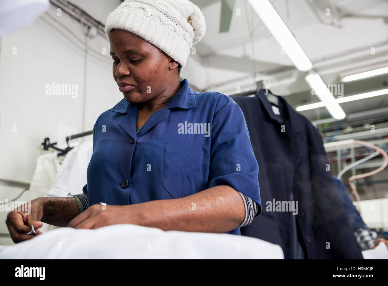 Worker ironing shirt in garment factory Stock Photo