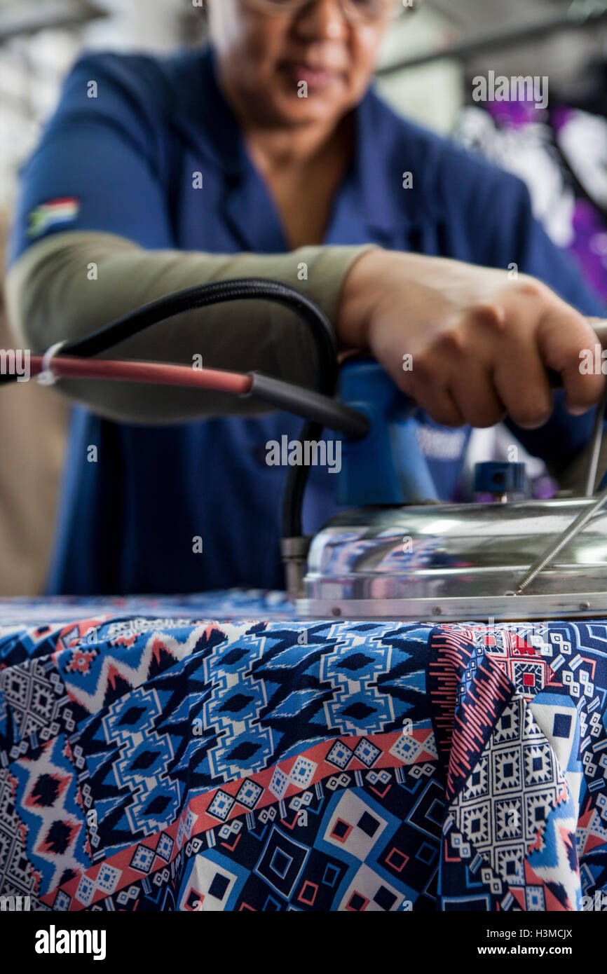 Worker ironing dress in garment factory Stock Photo