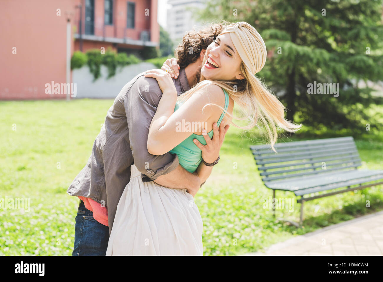 Couple hugging in park Stock Photo