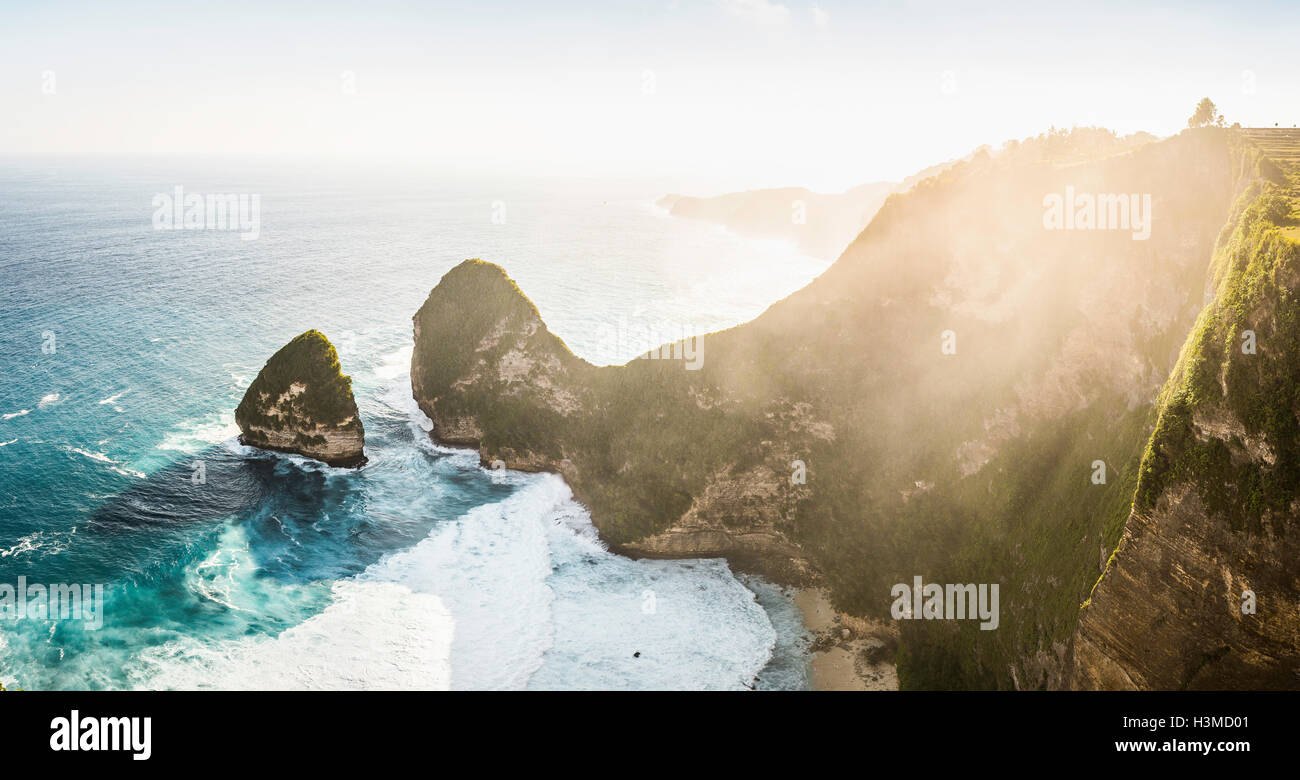 High angle sunlit view of rock formation and sea, Peluwang, South Coast, Nusa Penida, Indonesia Stock Photo
