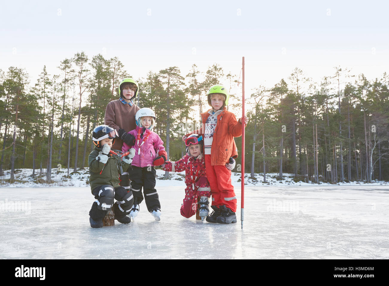 Portrait of girls and boys wearing skiing helmets on frozen lake, Gavle, Sweden Stock Photo