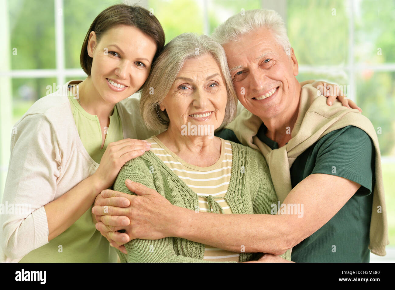 Happy senior parents with daughter Stock Photo