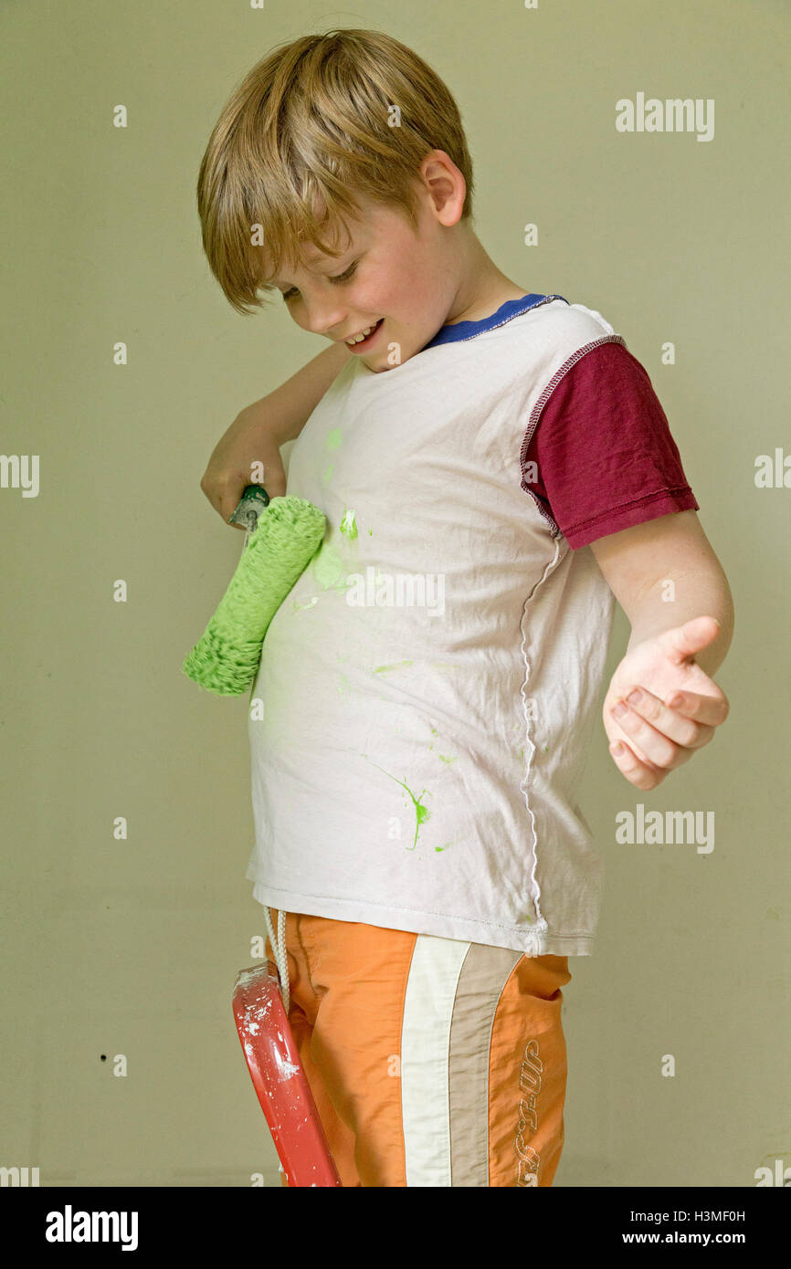 young boy painting his T-shirt Stock Photo