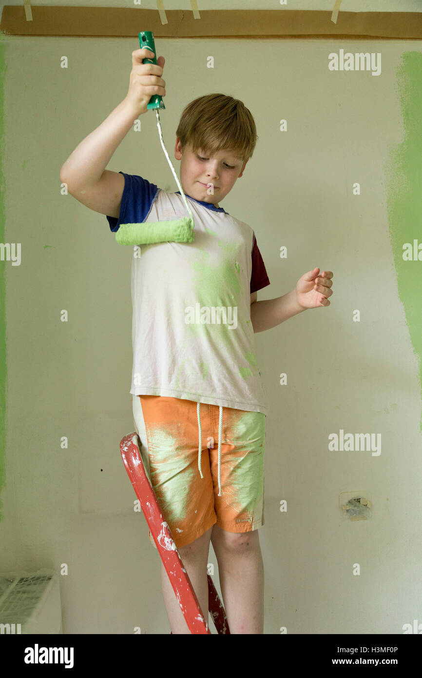 young boy painting his T-shirt Stock Photo
