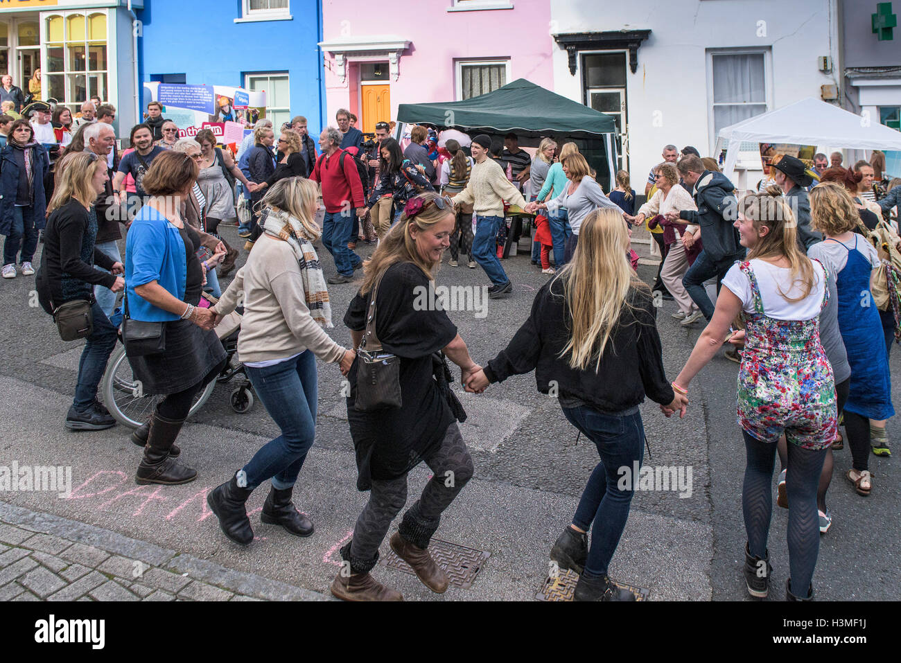 Members of the public dancing in the street at the Penryn Festival in Cornwall Stock Photo