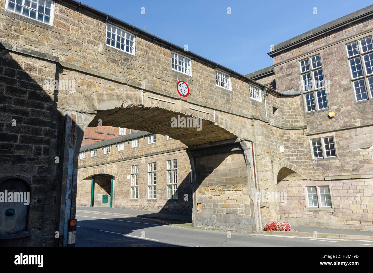 Bridge over the road at Belper North Mill, a former cotton mill in the Derbyshire town of Belper Stock Photo