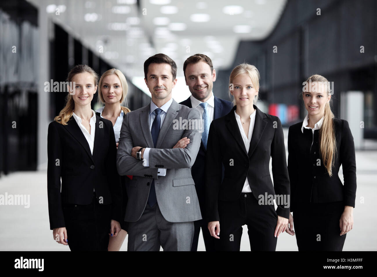 Portrait of successful smiling business team in office building Stock ...