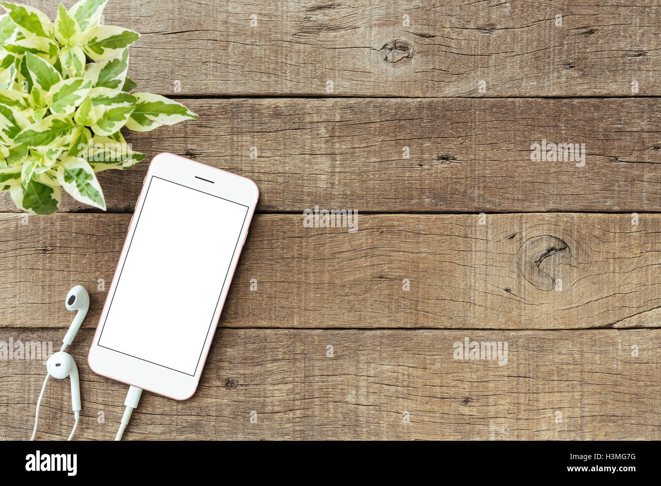 phone blank white screen on old wood table, mockup phone rose gold color Stock Photo