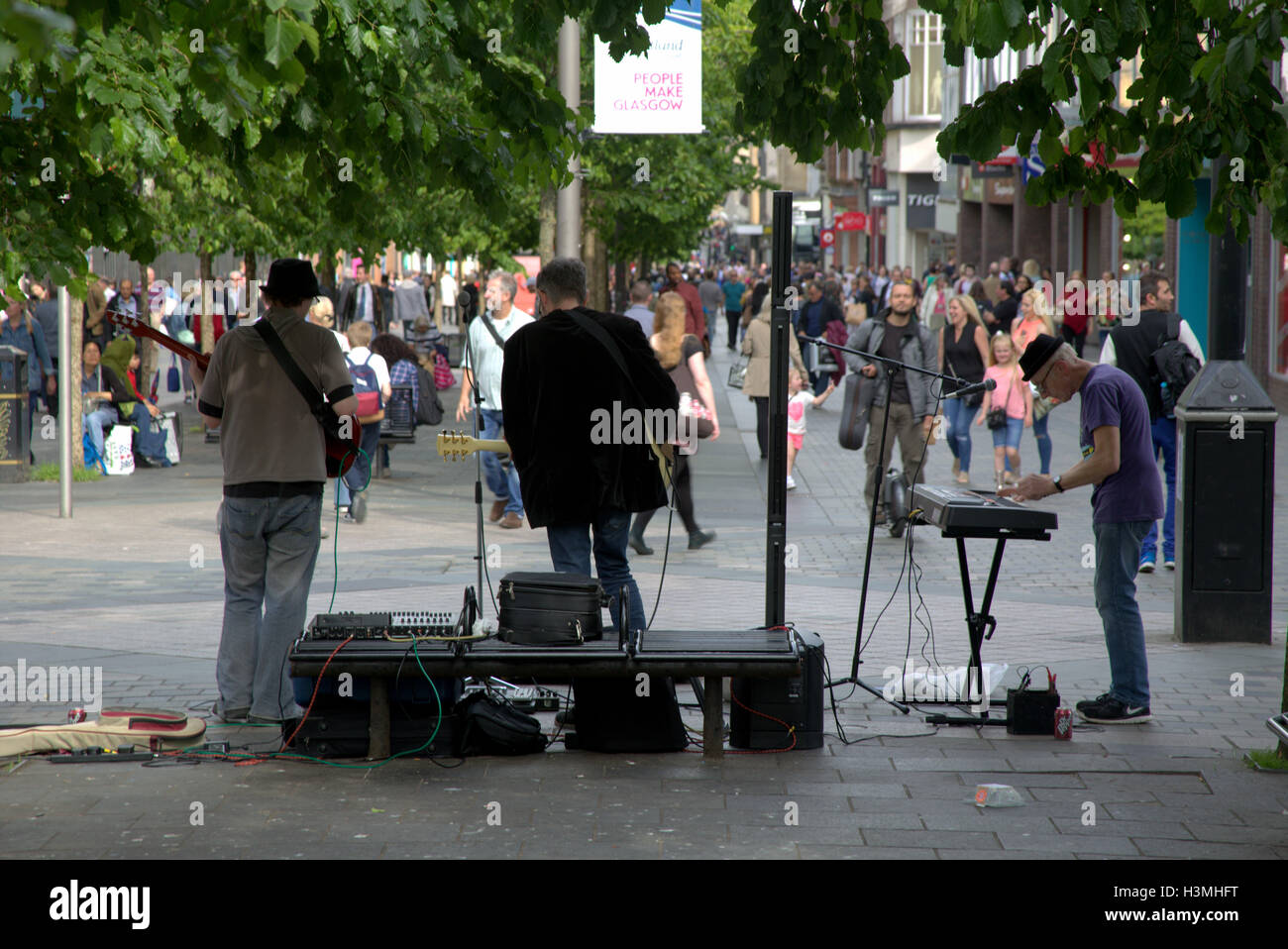 Street musicians busking on Sauchiehall Street, Glasgow Stock Photo