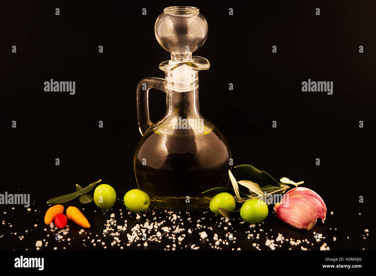 bottle with olive oil isolated on white background and ,garlic peppers Stock Photo