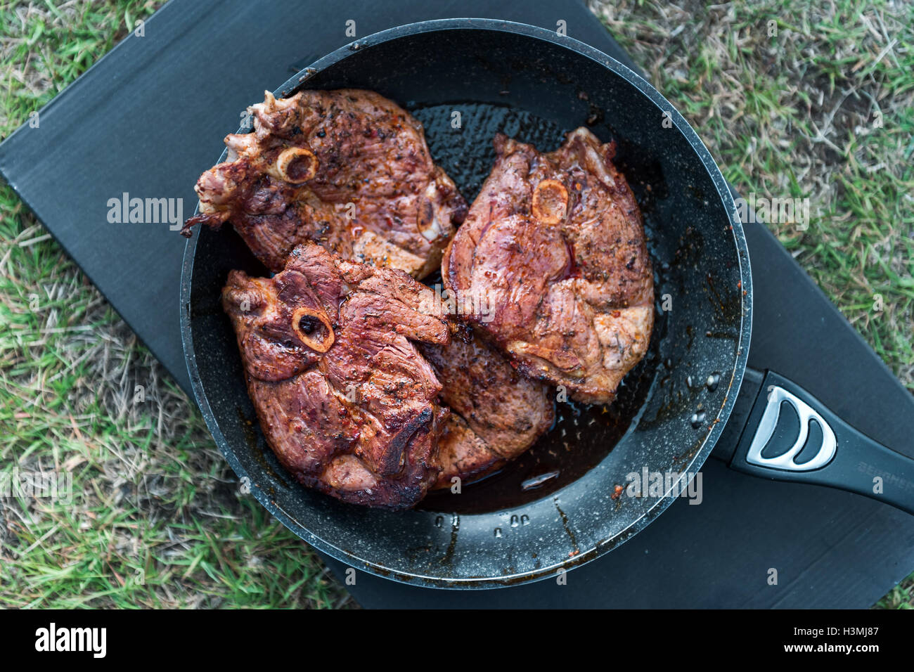 mutton steak on frying pan closeup Stock Photo