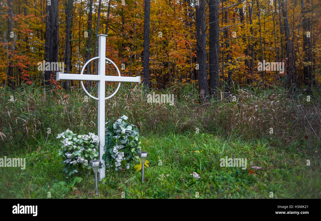 Unknown person grave marker in a deciduous forest. Stock Photo