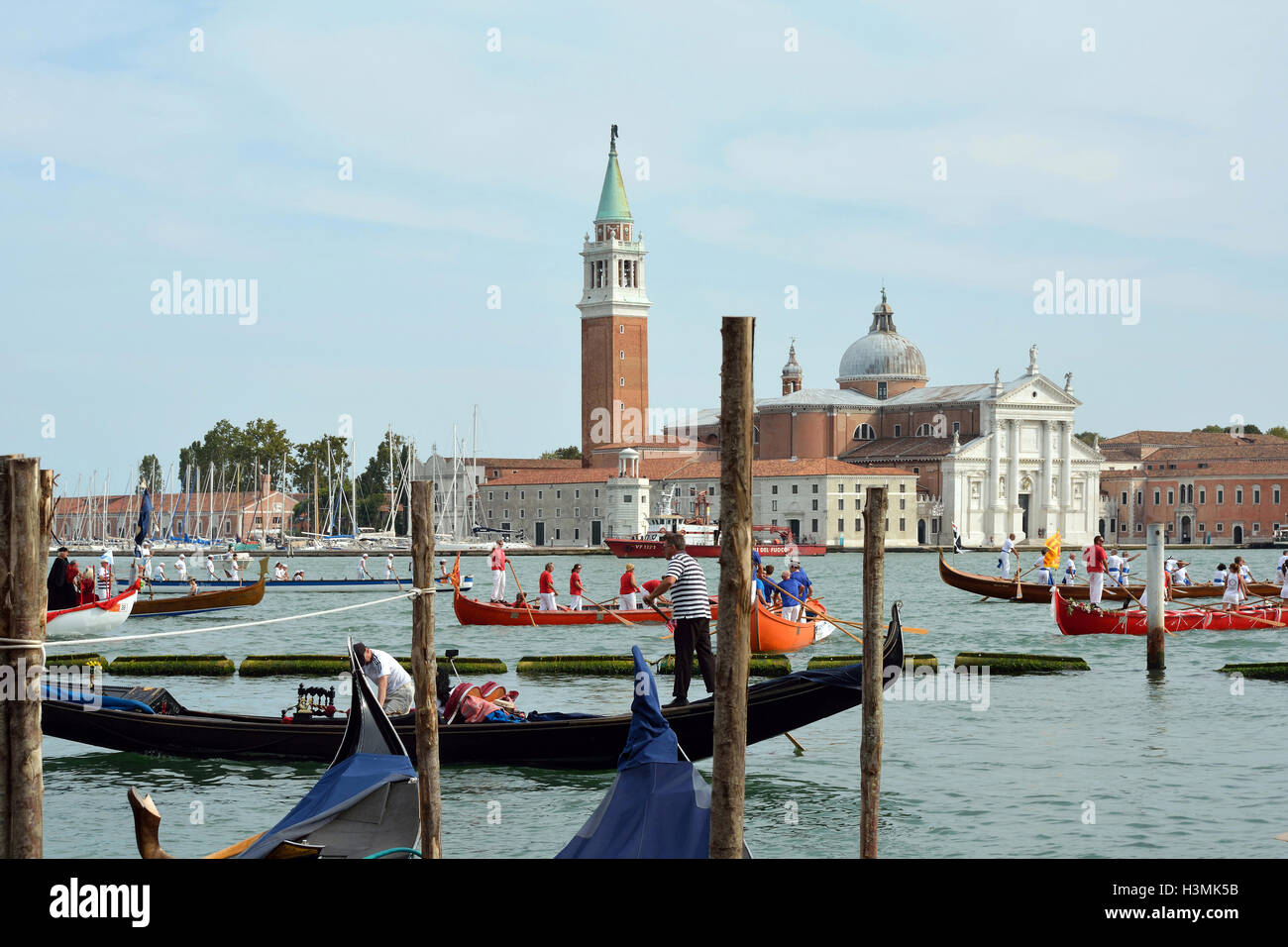 Historical boats parade befor the Island of San Giorgio Maggiore in the Lagoon of Venice in Italy. Stock Photo