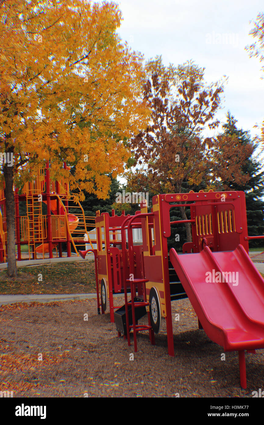 fire engine in the park surrounded with yellow fall trees Stock Photo