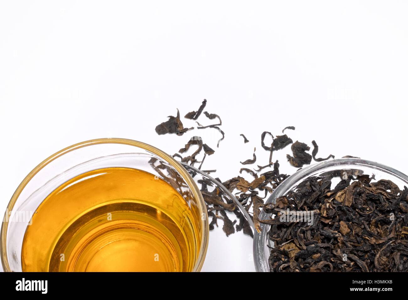 Glass cup of tea and dried tea on white copy space Stock Photo