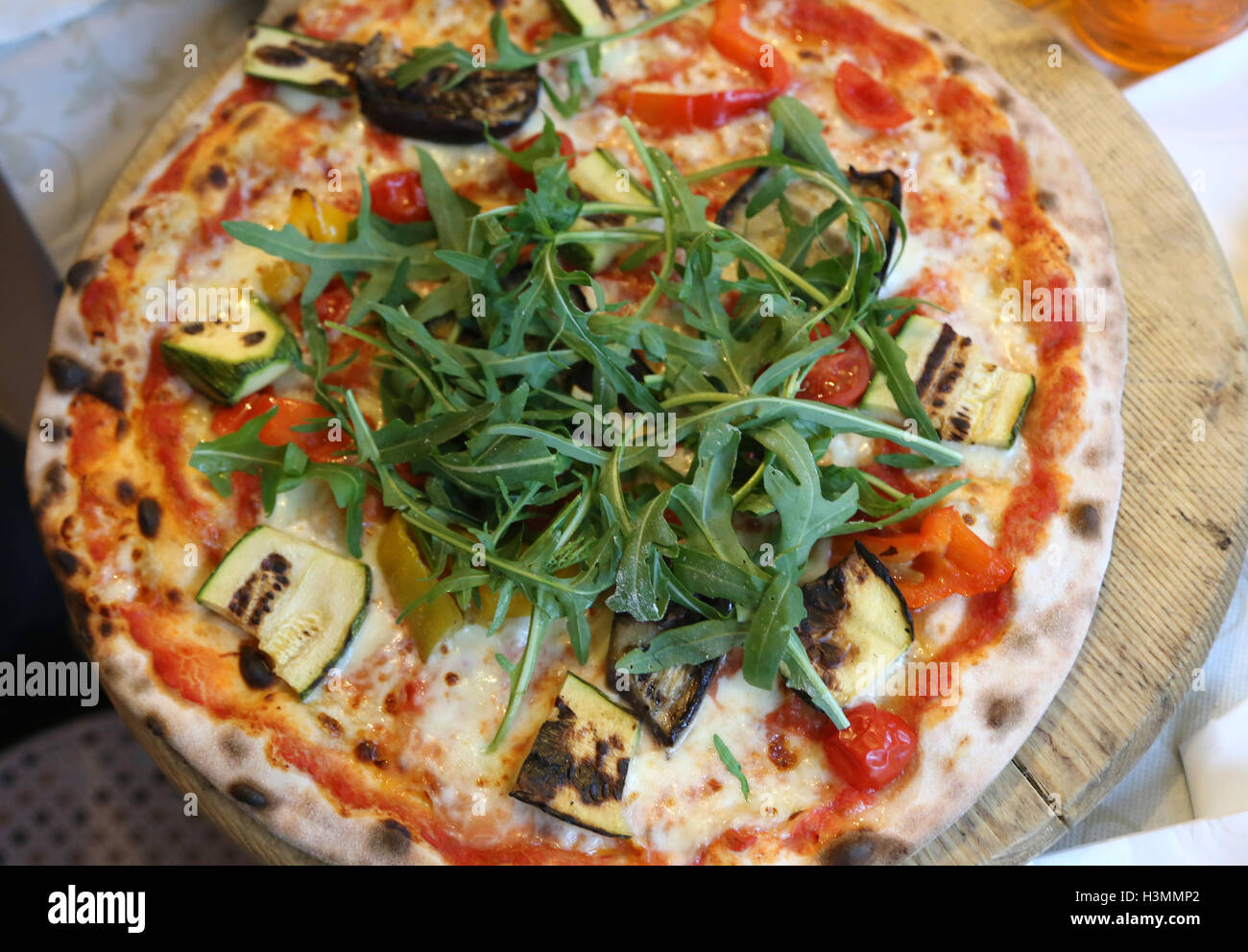fragrant pizza with zucchini and arugula and fresh tomatoes Stock Photo