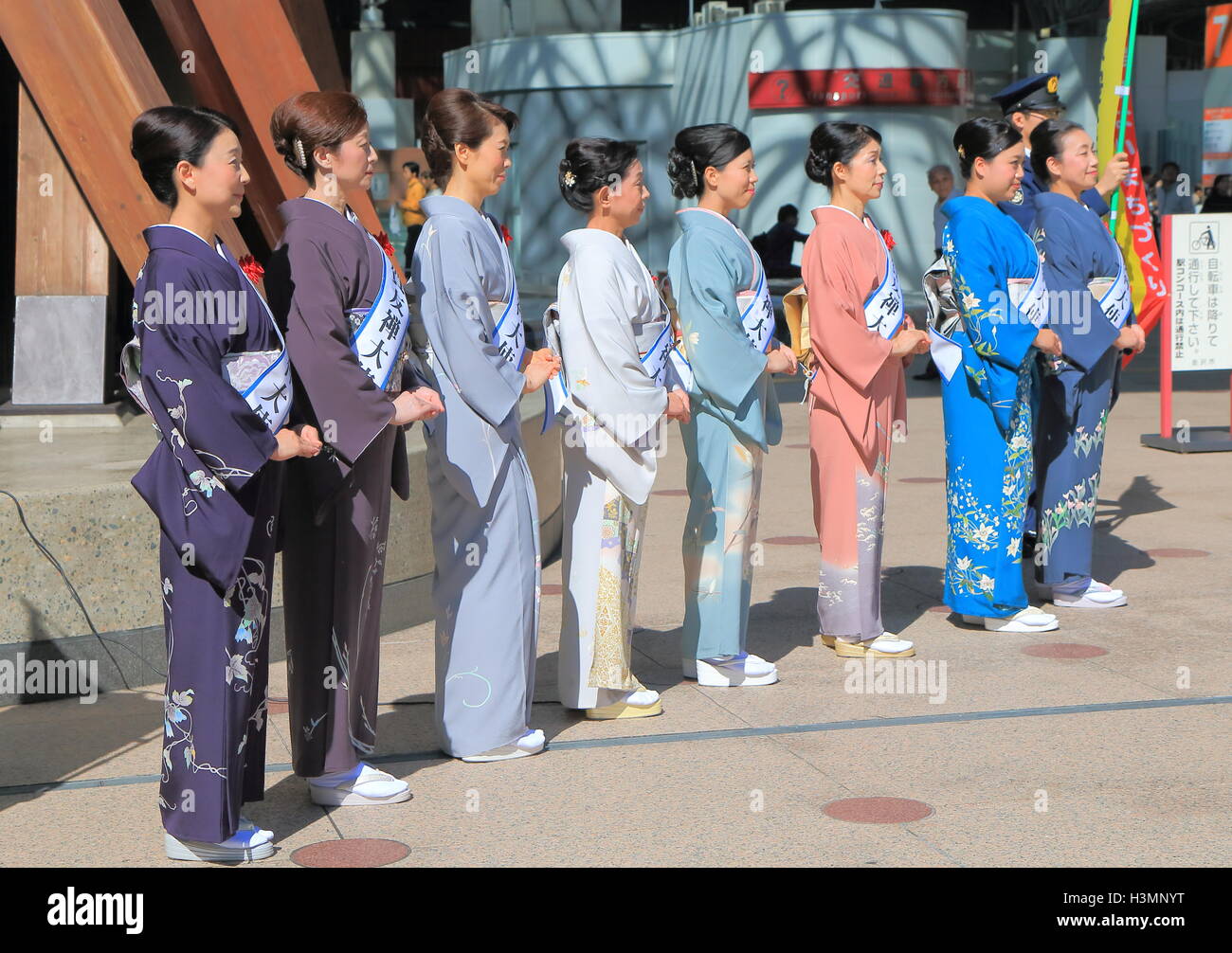 Kimono models welcome tourists at Kanazawa Train Station in Kanazawa Japan. Stock Photo