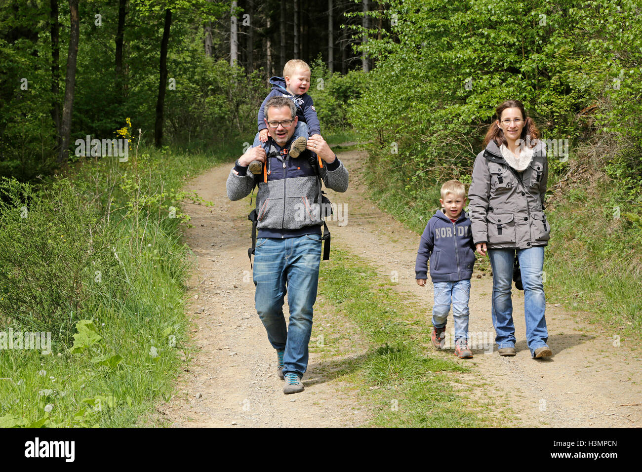 young family going for walk in the woods Stock Photo