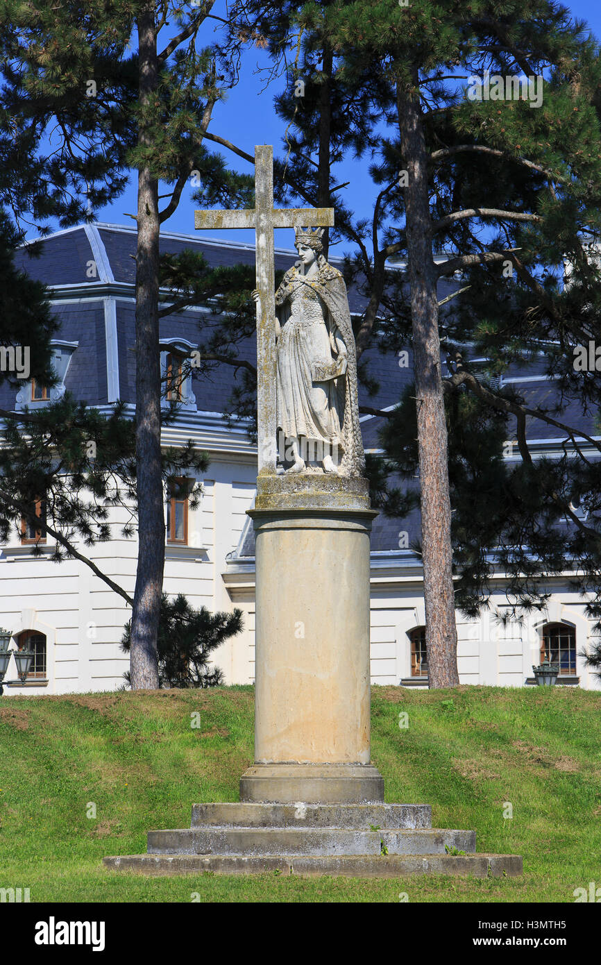 Baroque statue of Saint Helen holding a cross in the gardens of the Festetics Palace (1745) in Keszthely, Hungary Stock Photo