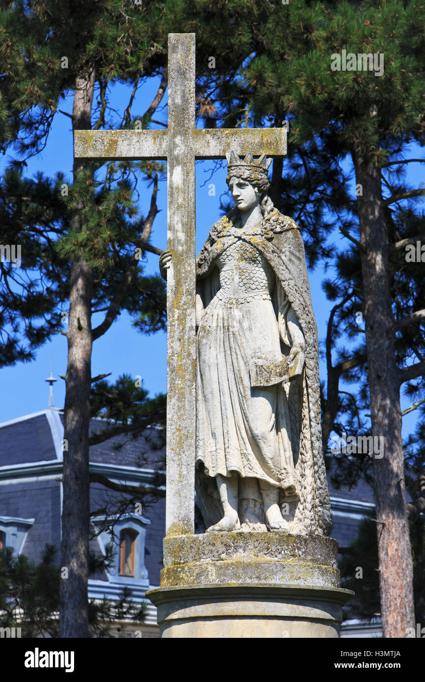 Baroque statue of Saint Helen holding a cross in the gardens of the Festetics Palace (1745) in Keszthely, Hungary Stock Photo