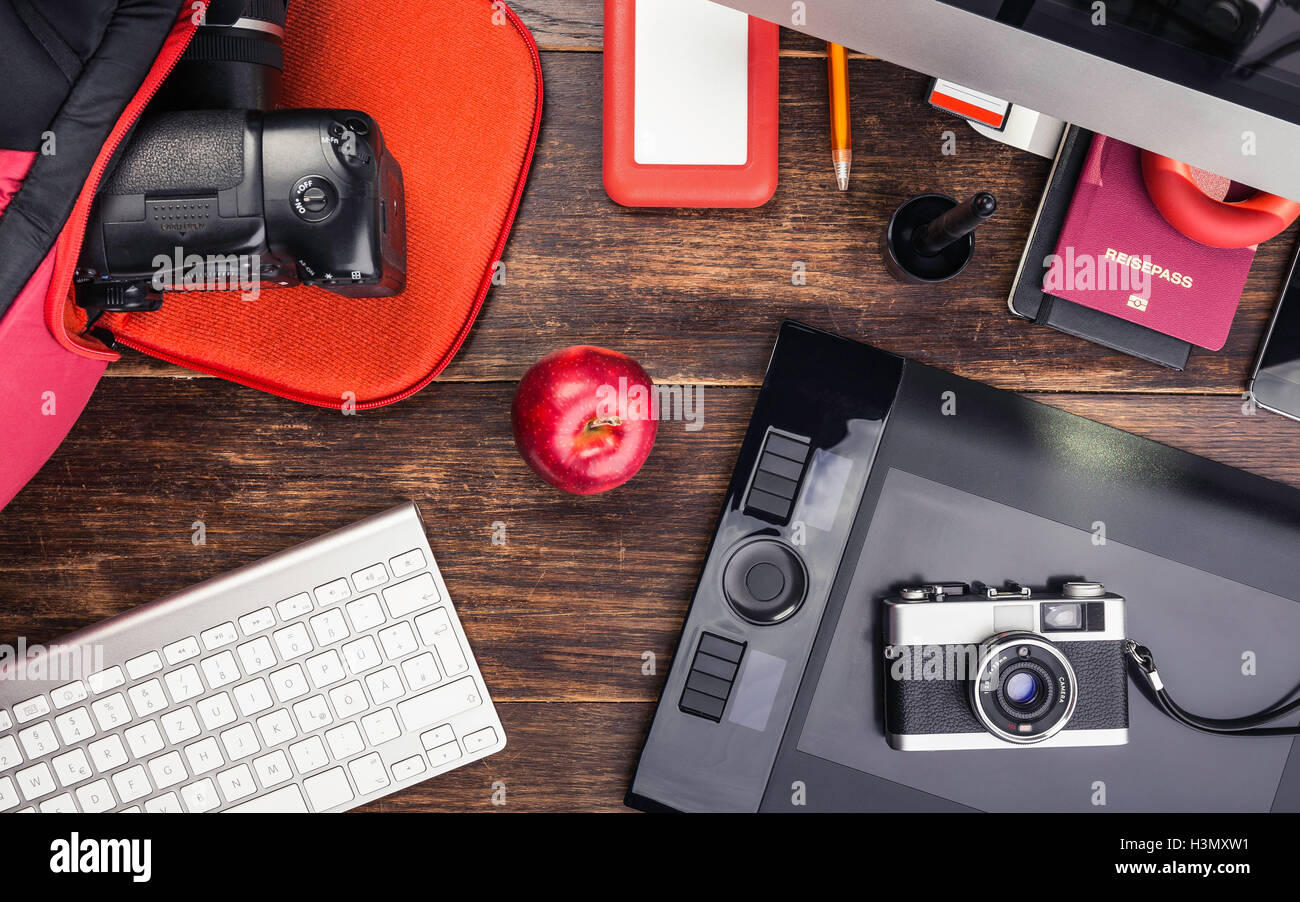 Overhead view of photo editing equipment; graphic tablet, retro camera