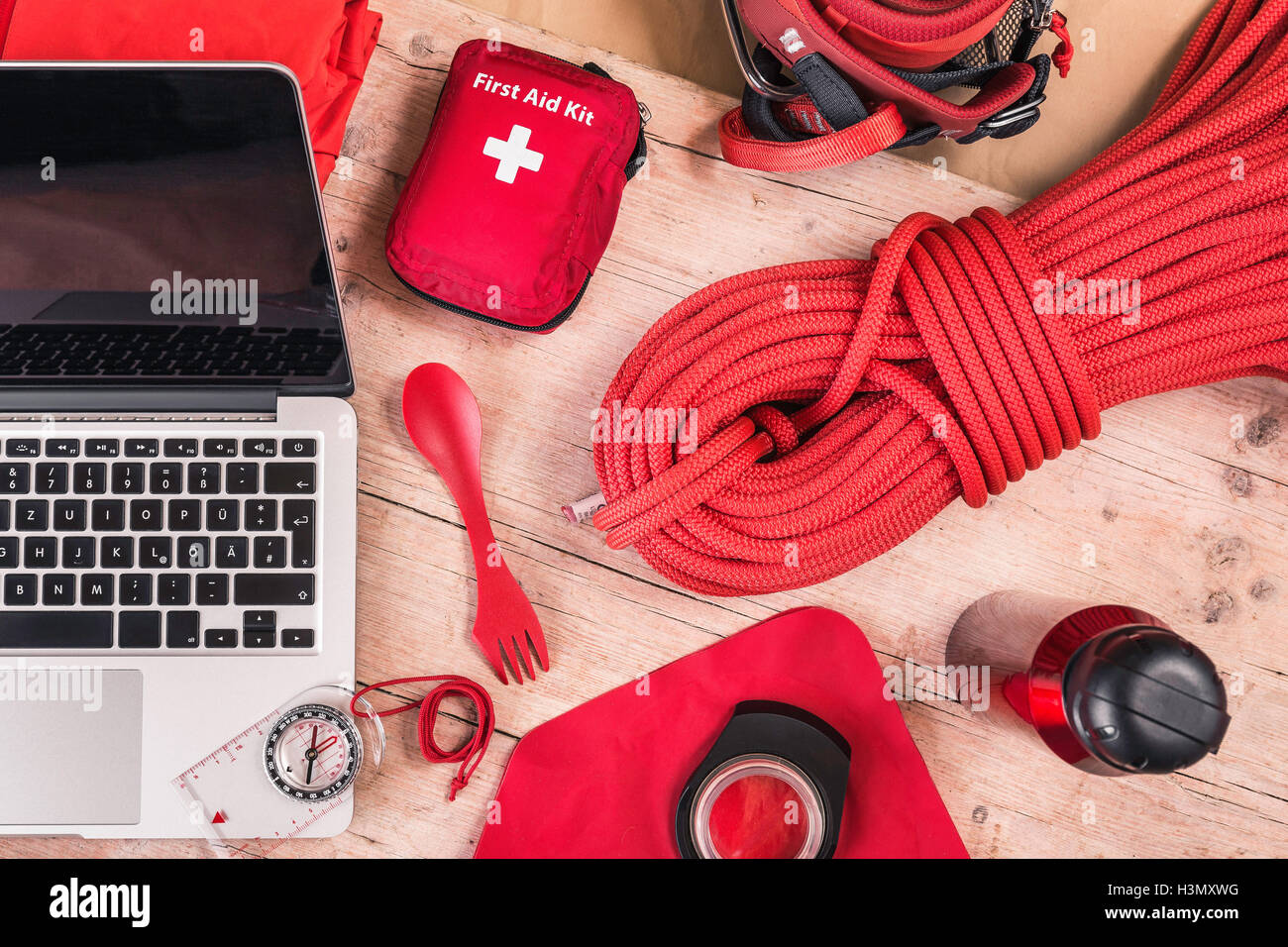 Overhead view of climbing equipment packing with red first aid kit