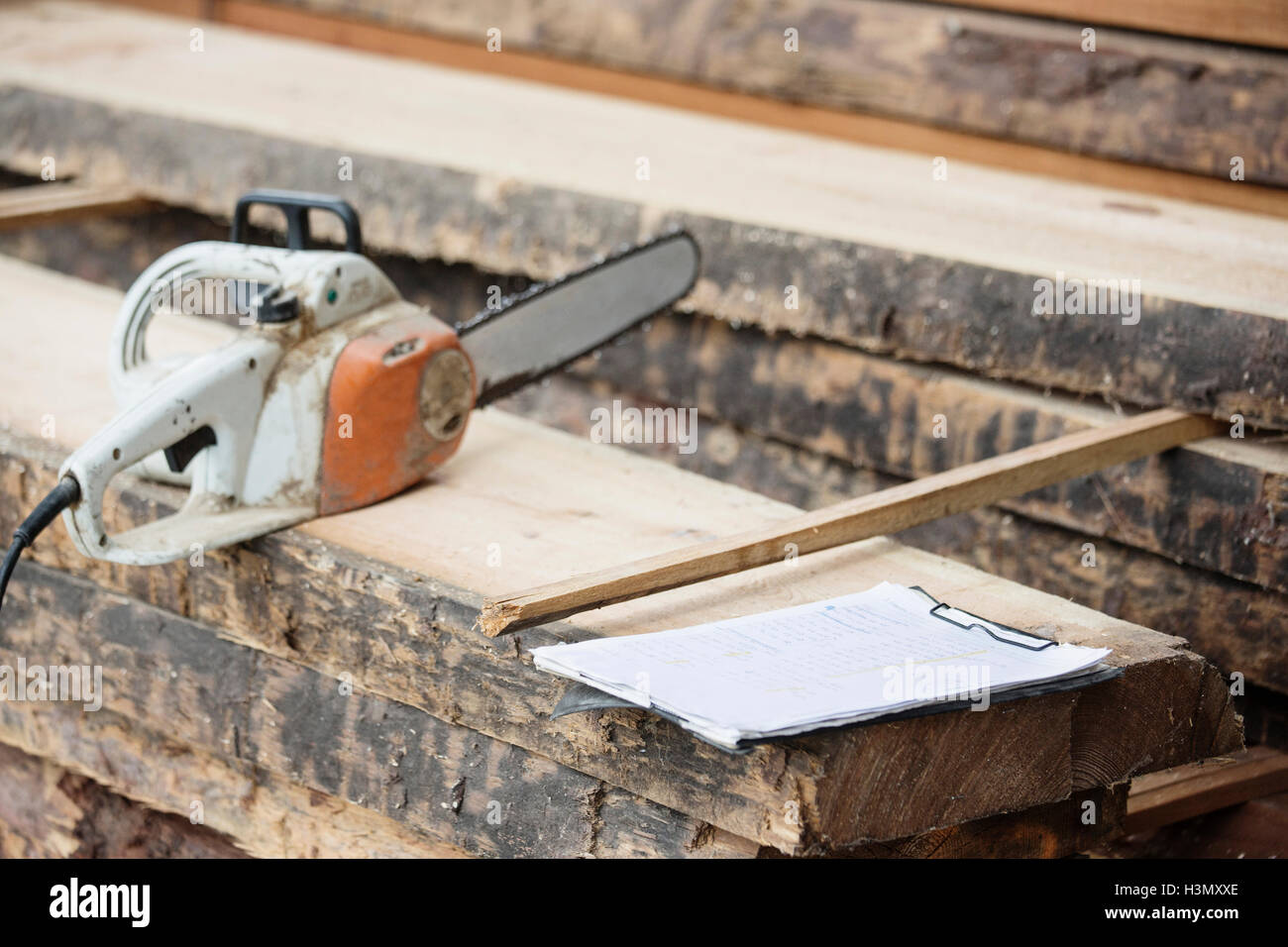 Electric saw on wooden plank Stock Photo