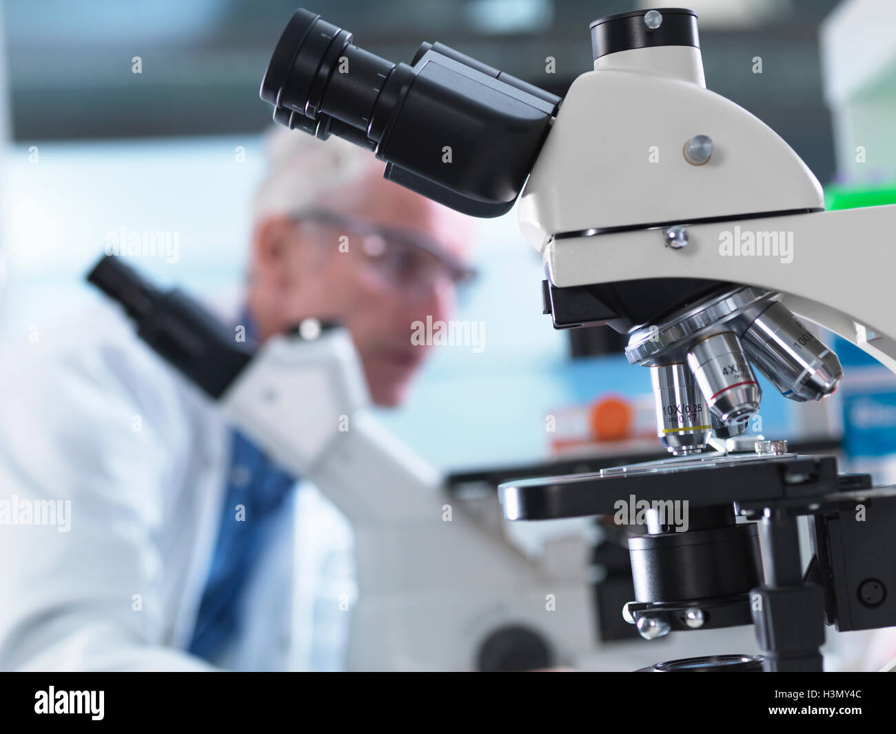 Microscopes being used during an experiment in a laboratory Stock Photo