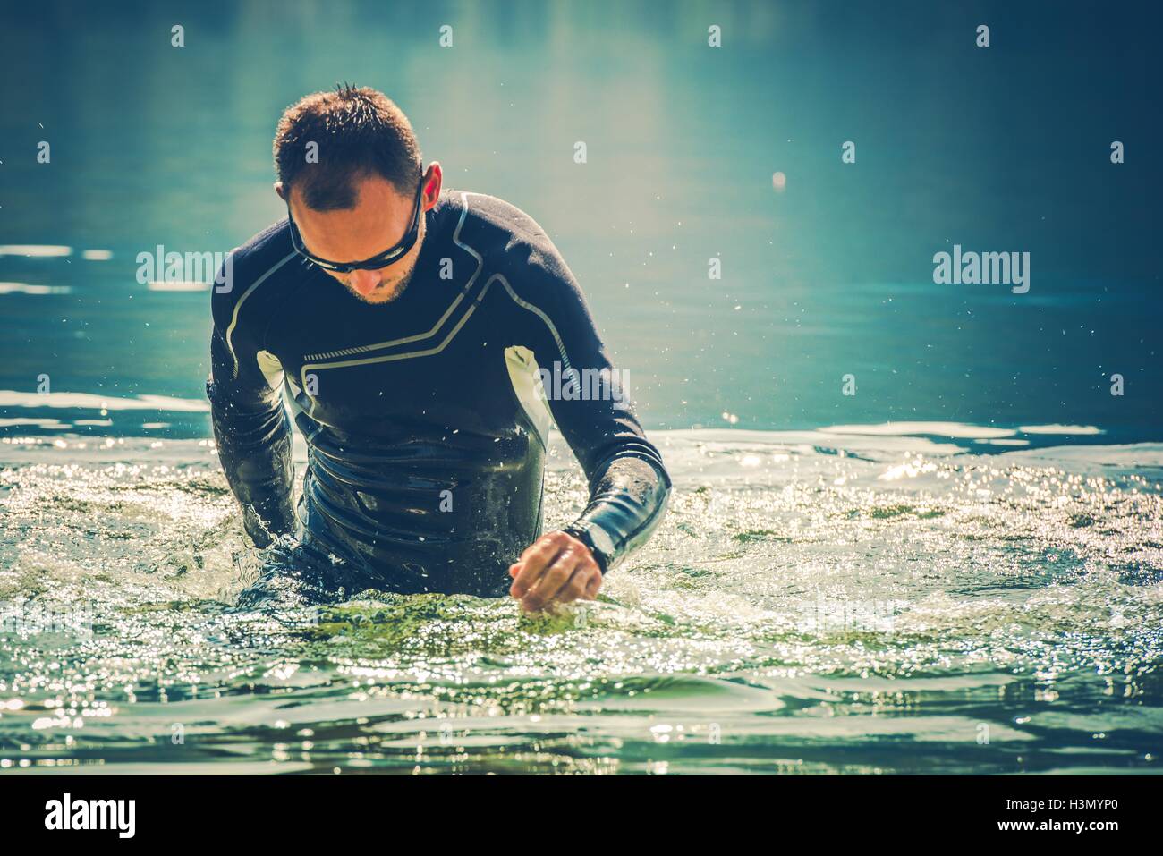 Wetsuit Water Sports. Caucasian Sportsman in the Black Wetsuit. Stock Photo