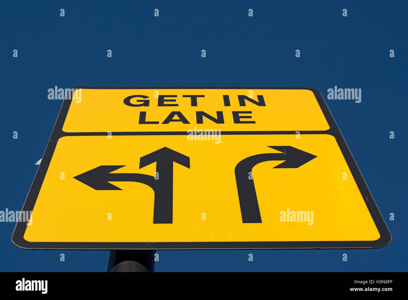 british road signs instructing driver to get in lane, to proceed straight ahead or to  turn left, or to turn right Stock Photo