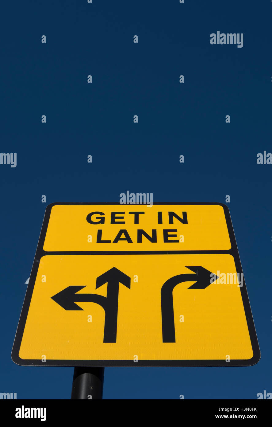 british road sign instructing driver to get in lane, to proceed straight ahead or to  turn left, or to turn right Stock Photo
