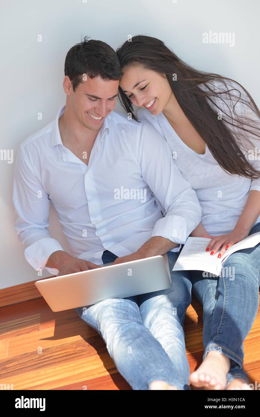 young couple using laptop at home Stock Photo - Alamy