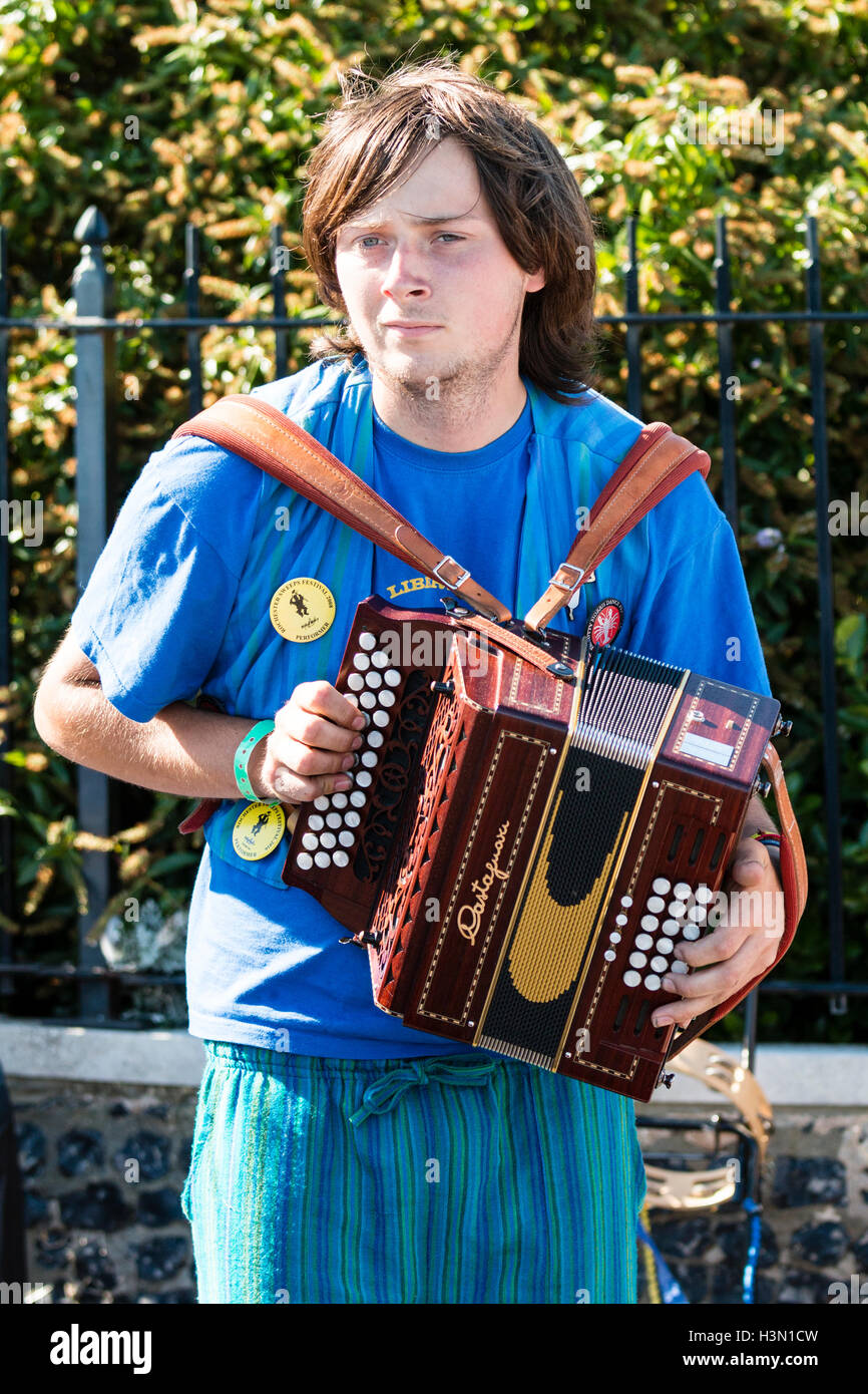 Legs of a young adult man sitting playing an accordion in a room Stock  Photo - Alamy