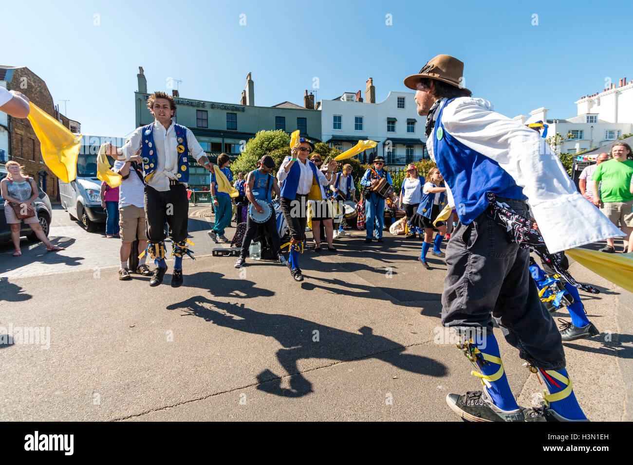 Traditional English Folk Dancers, Royal Liberty Morris, dancing on promenade and waving yellow hankies during the summertime Broadstairs Folk week. Stock Photo
