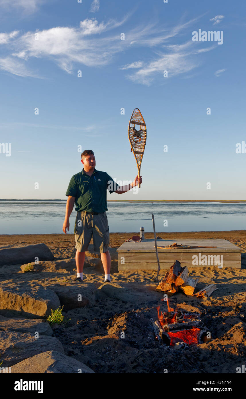 Canadian National Park ranger giving a speech by a campfire in ...
