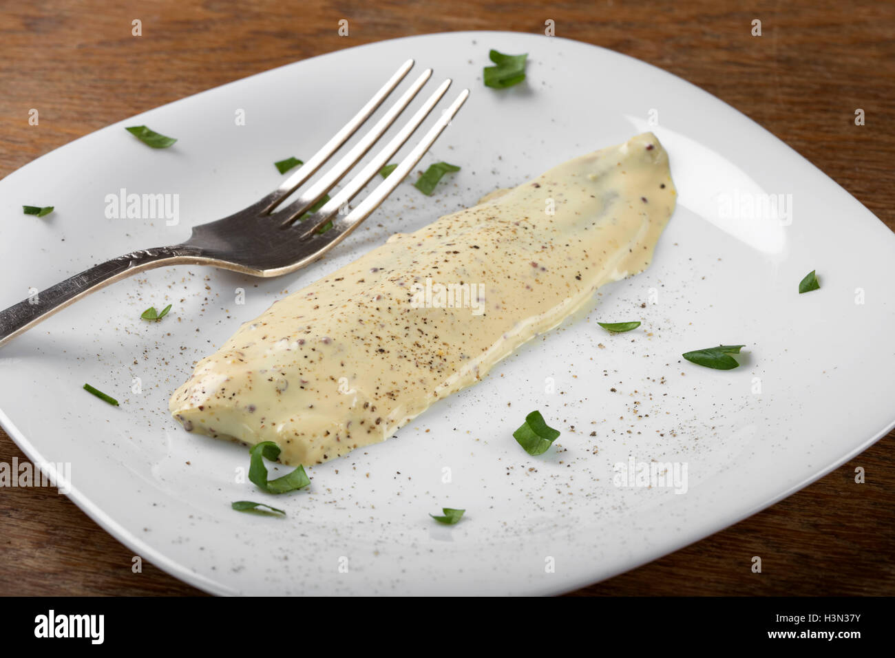 Plate with herring fillets in mustard sauce and herbs Stock Photo Alamy