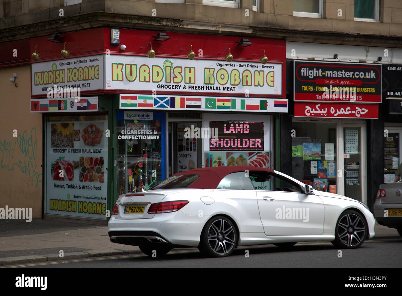 Kurdish business in Britain UK with Turkish origins emphasizing Kurd roots, grocery shop and barber shop or hairdressers Stock Photo