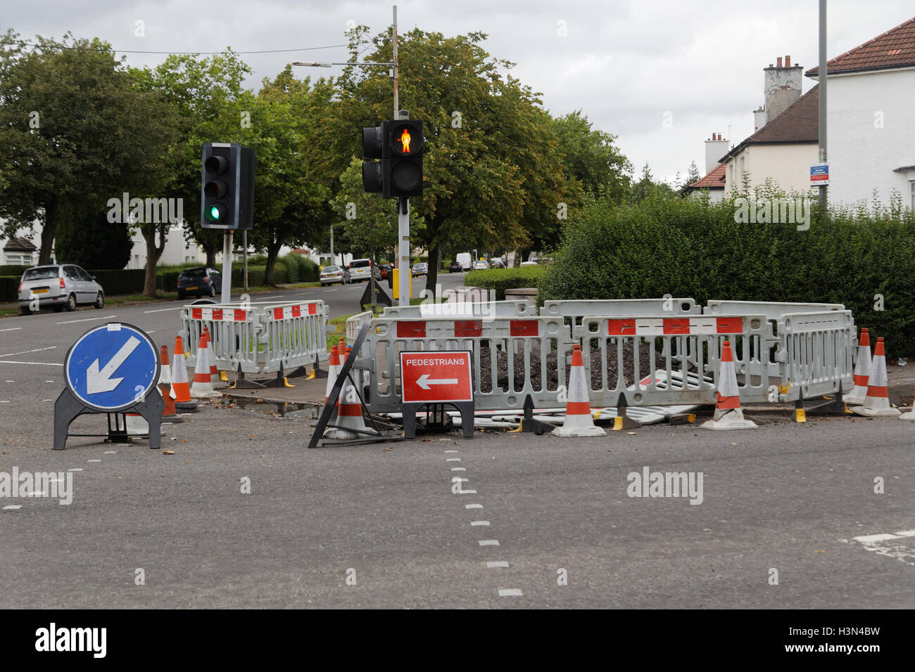roadworks with diversion sign and traffic cones traffic lights Stock Photo