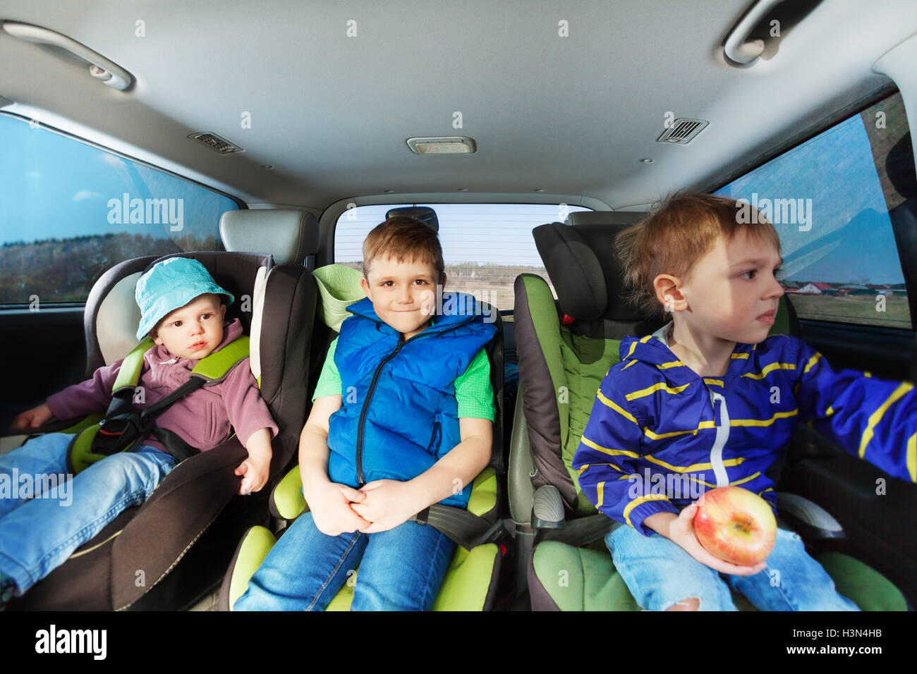 https://c8.alamy.com/comp/H3N4HB/three-little-boys-sitting-in-safety-car-seats-H3N4HB.jpg