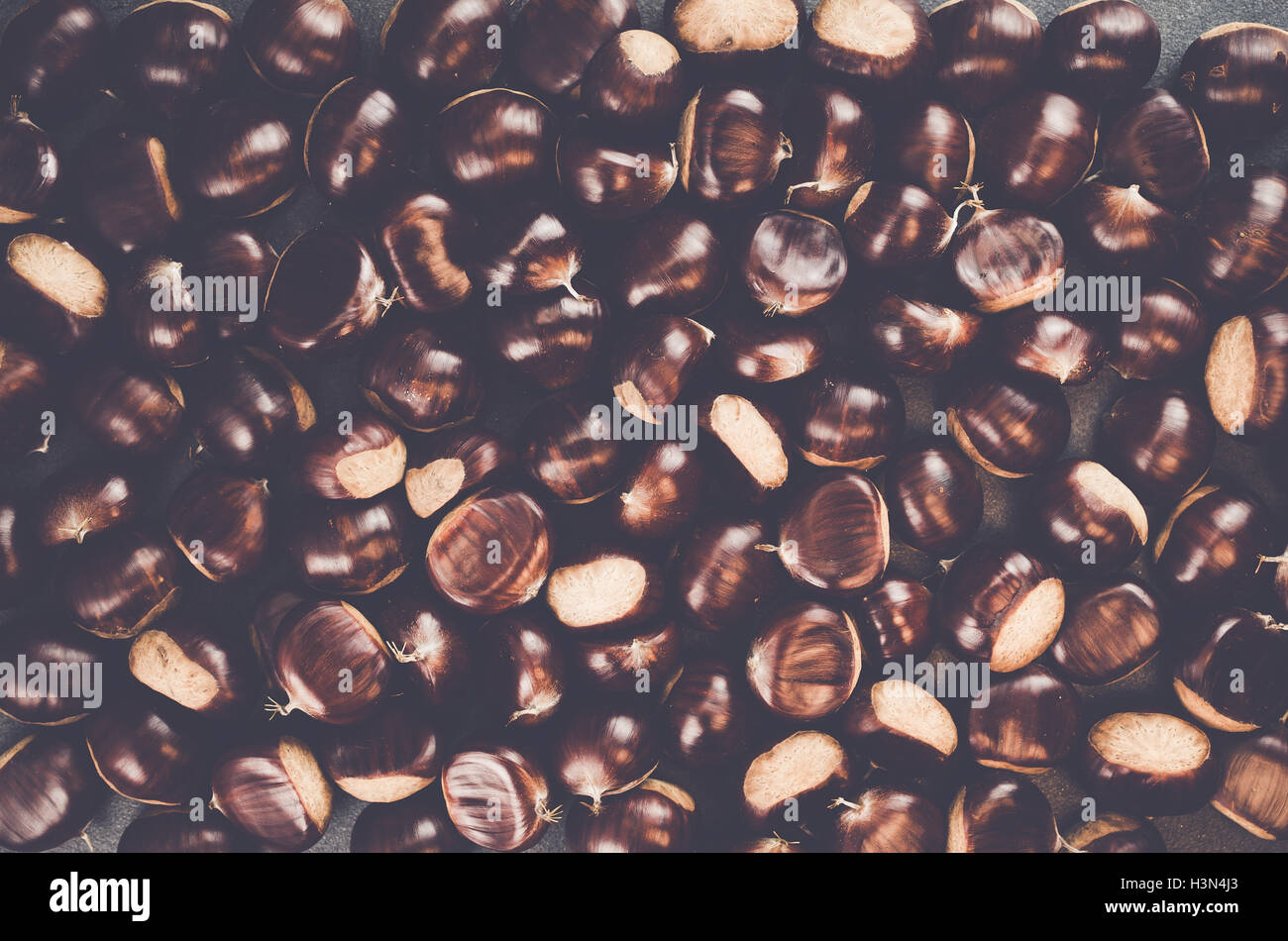 ripe chestnuts on a slate background - seasonal fruits Stock Photo - Alamy