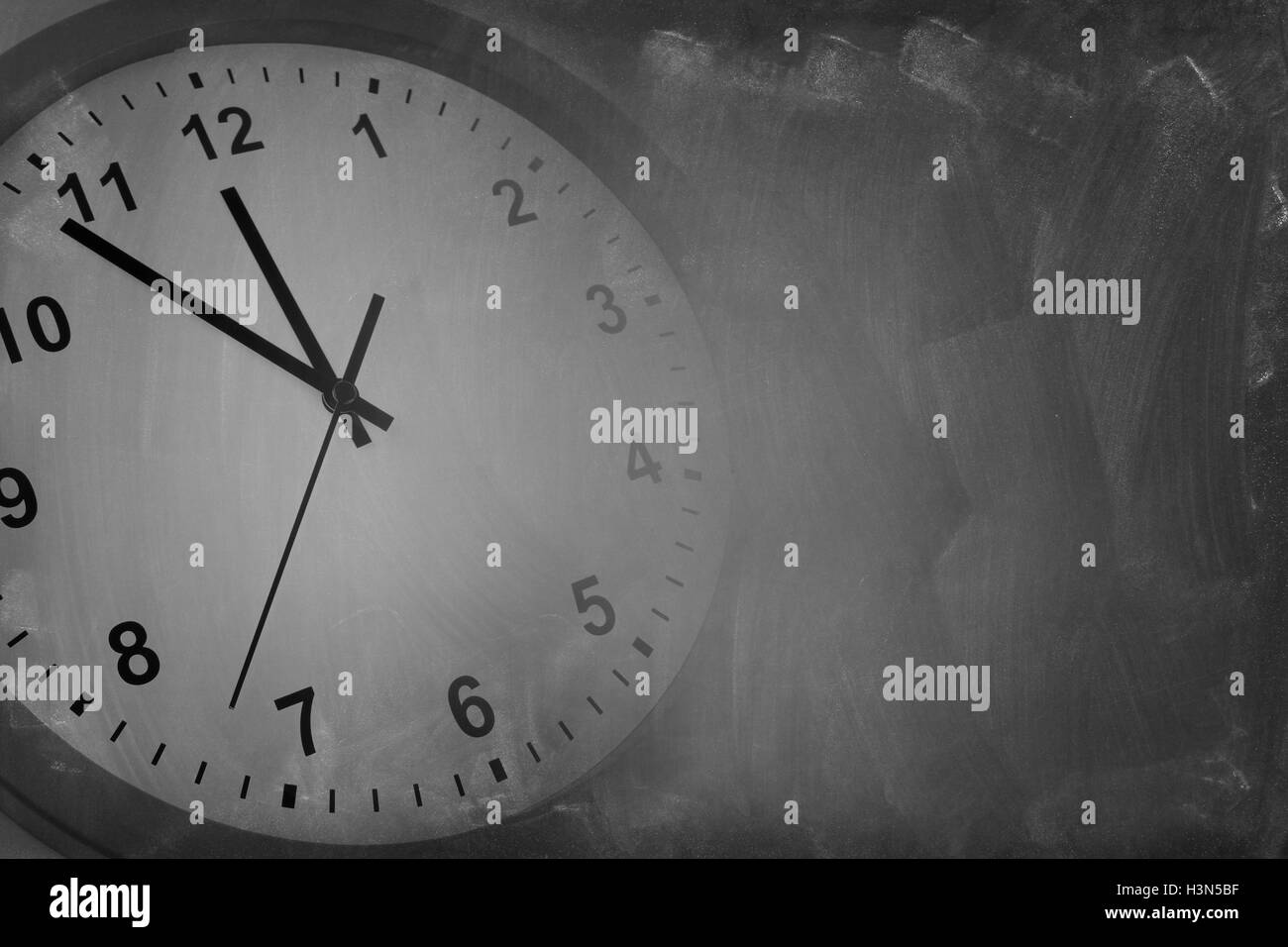 Clock blending into a blackboard Stock Photo